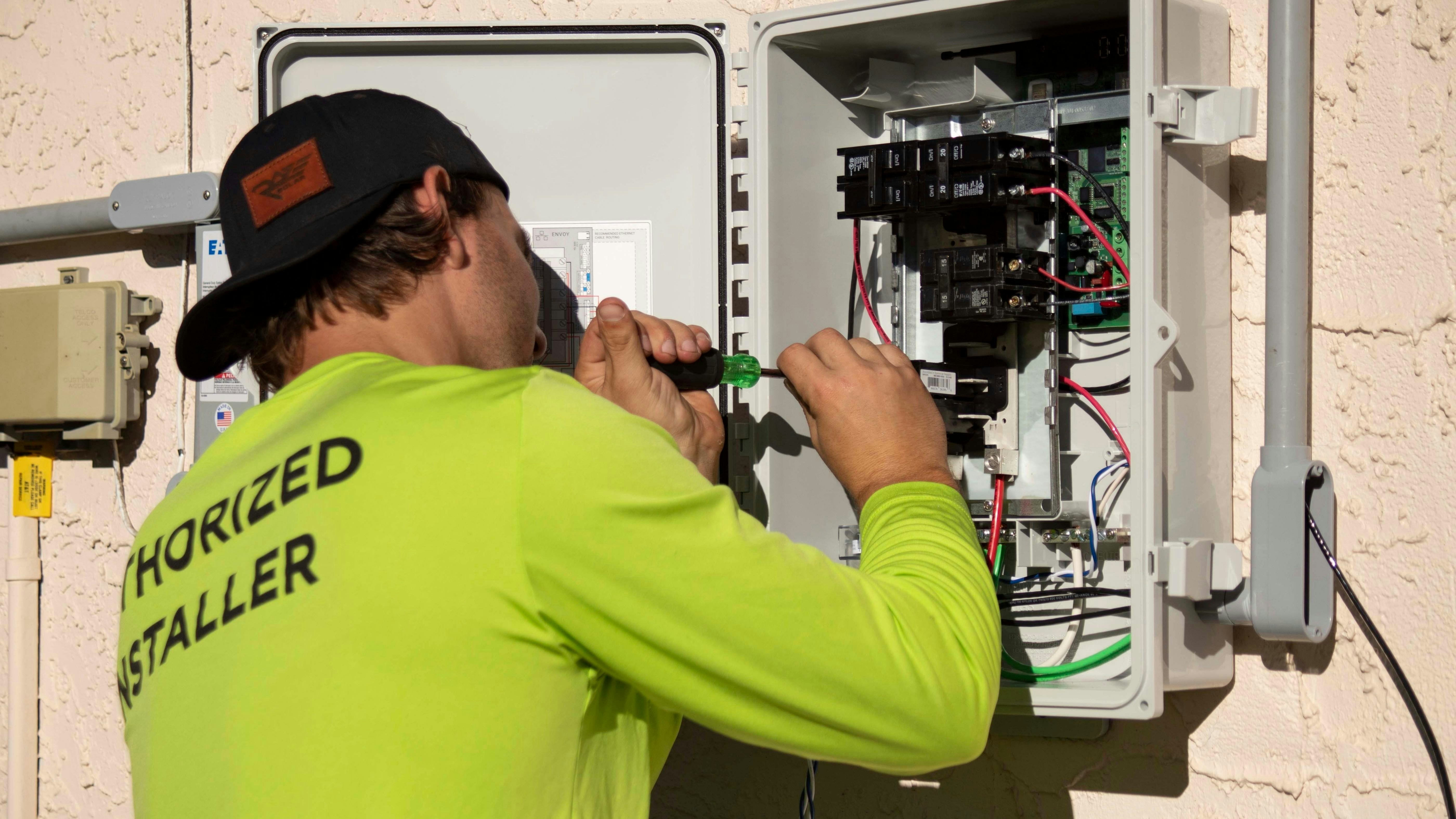 Certified electrician servicing an electrical panel in Tirupur